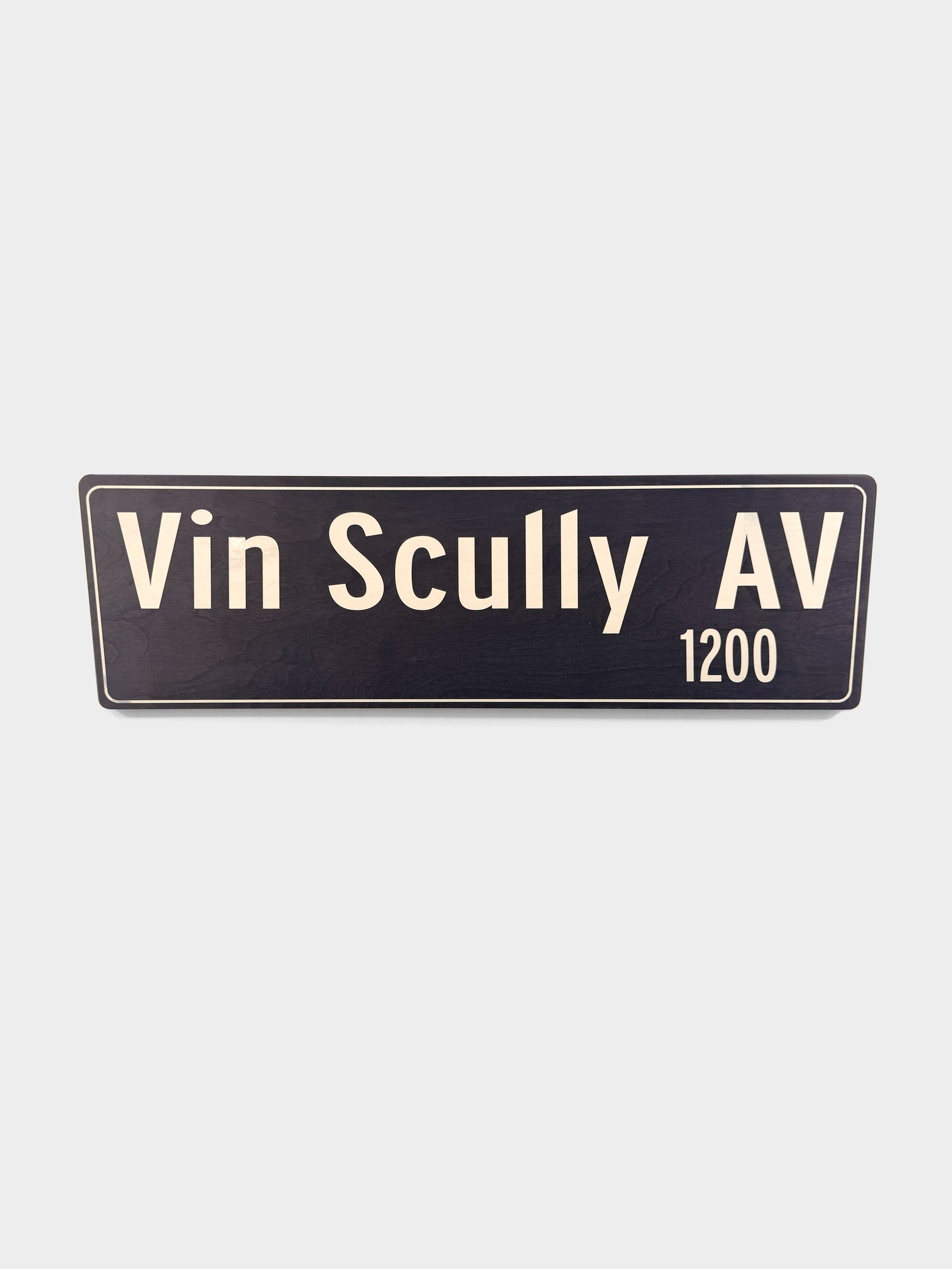 Pacific Stranded Vin Scully AV 1200 street sign, dark blue with cream lettering, 30" wide.